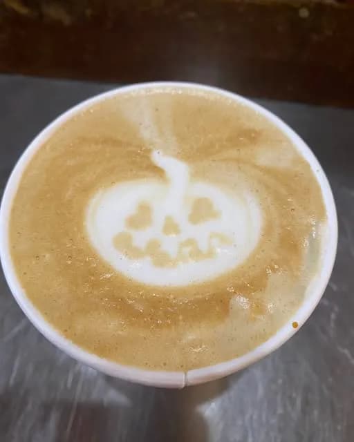 A latte with pumpkin latte art